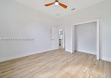 unfurnished bedroom with ceiling fan, a closet, and light hardwood / wood-style floors