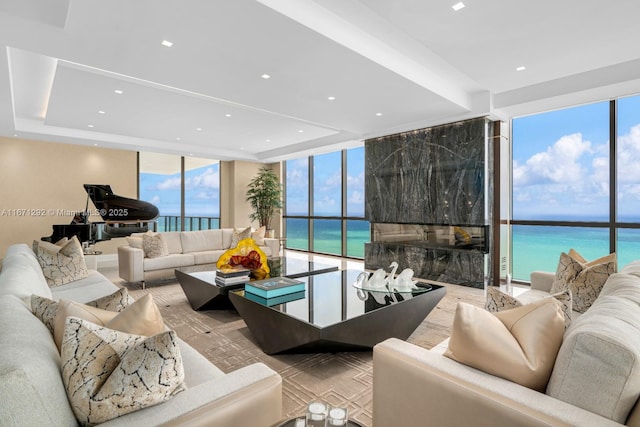 living room featuring a water view and expansive windows