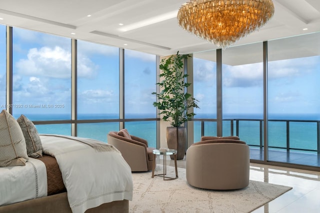 bedroom featuring a water view, expansive windows, and multiple windows