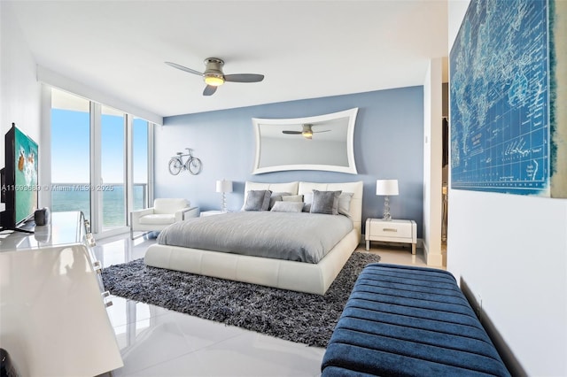 tiled bedroom featuring ceiling fan, floor to ceiling windows, a water view, and access to outside