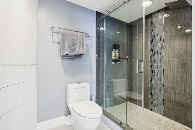 bathroom with an enclosed shower and toilet