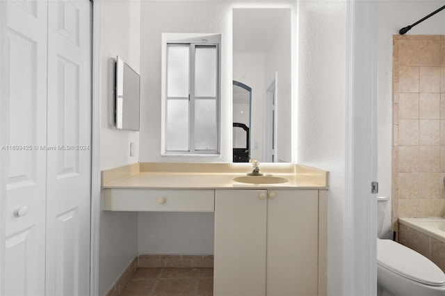 full bathroom with tile patterned flooring, vanity, toilet, and tiled shower / bath