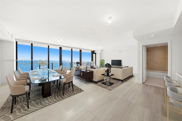 dining area featuring plenty of natural light and a wall of windows