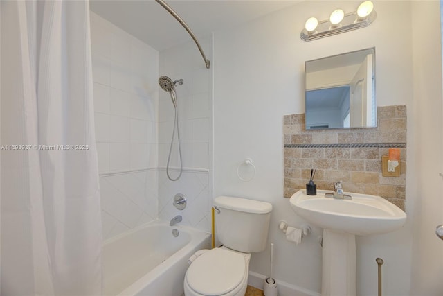 bathroom with shower / bath combo, tasteful backsplash, and toilet