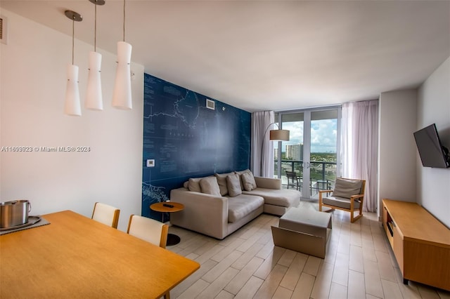 2602 E Hallandale Beach Blvd Unit R1606, Hallandale Beach, FL 33009 - living room featuring floor to ceiling windows, an accent wall, and light wood-style flooring