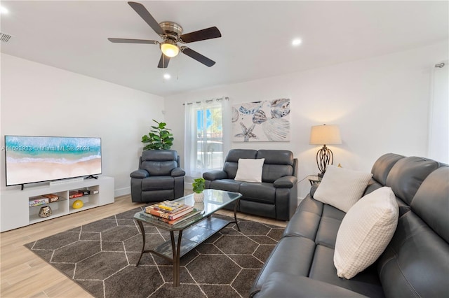 living room with hardwood / wood-style flooring and ceiling fan