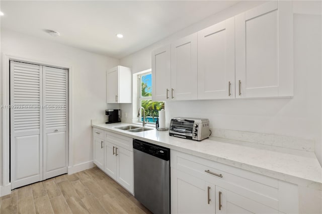 kitchen with dishwasher, light hardwood / wood-style floors, white cabinets, and sink