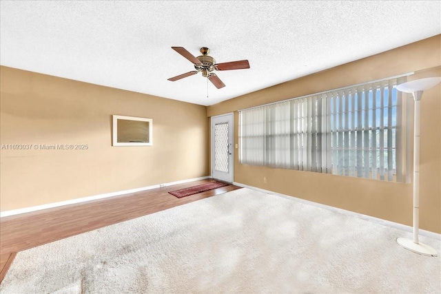 13500 SW 1st St Unit 307U, Pembroke Pines, FL 33027 - unfurnished room featuring baseboards, ceiling fan, wood finished floors, and a textured ceiling
