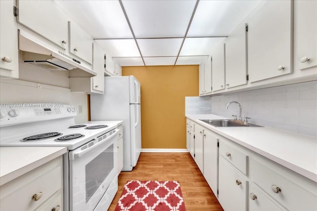 13500 SW 1st St Unit 307U, Pembroke Pines, FL 33027 - kitchen featuring white range with electric stovetop, a sink, under cabinet range hood, decorative backsplash, and light countertops