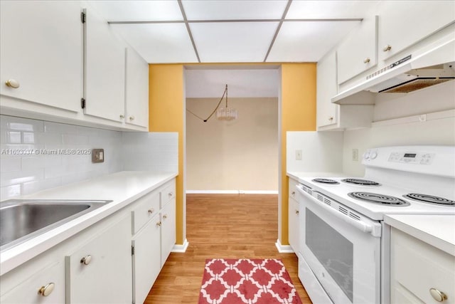 13500 SW 1st St Unit 307U, Pembroke Pines, FL 33027 - kitchen with white electric range oven, under cabinet range hood, light wood finished floors, light countertops, and decorative backsplash