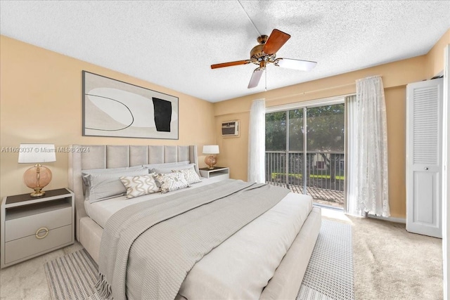 carpeted bedroom featuring access to outside, ceiling fan, a textured ceiling, and an AC wall unit