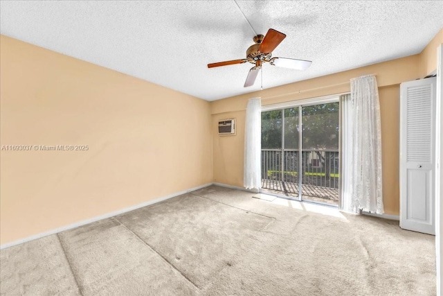 13500 SW 1st St Unit 307U, Pembroke Pines, FL 33027 - carpeted spare room featuring an AC wall unit, baseboards, a ceiling fan, and a textured ceiling
