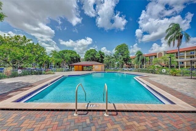 13500 SW 1st St Unit 307U, Pembroke Pines, FL 33027 - community pool featuring fence
