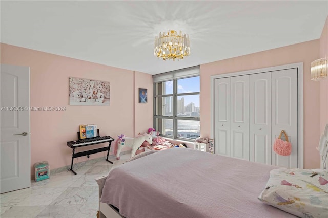 bedroom with a closet and an inviting chandelier