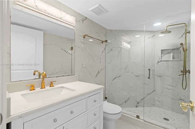 bathroom with vanity, toilet, and a shower with shower door