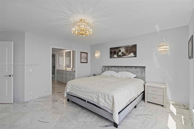 bedroom featuring an inviting chandelier and ensuite bath