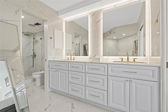 bathroom with vanity, toilet, and tiled shower