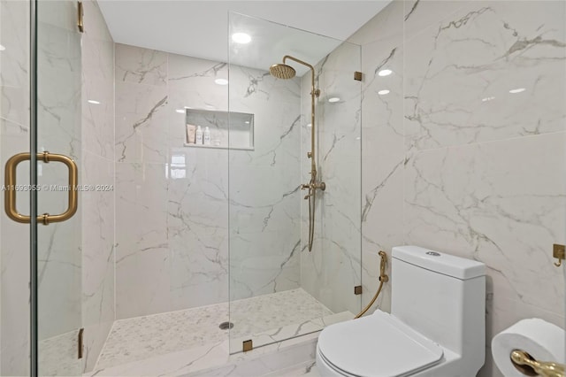 bathroom featuring toilet, an enclosed shower, and tile walls