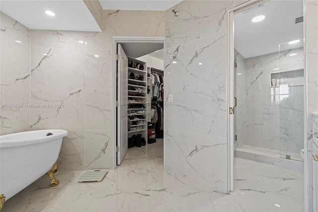 bathroom with separate shower and tub and tile walls