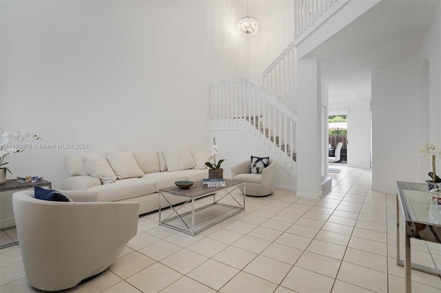 living room featuring a notable chandelier and light tile patterned flooring