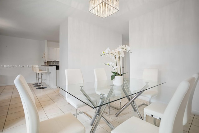 dining room featuring light tile patterned flooring and an inviting chandelier