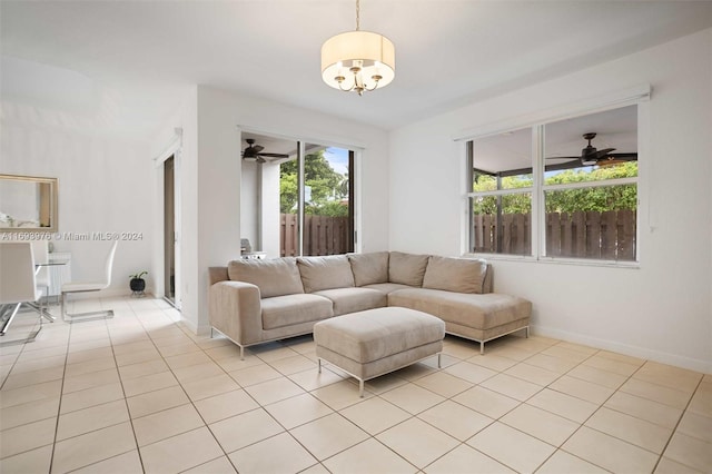 living room with ceiling fan with notable chandelier and light tile patterned flooring