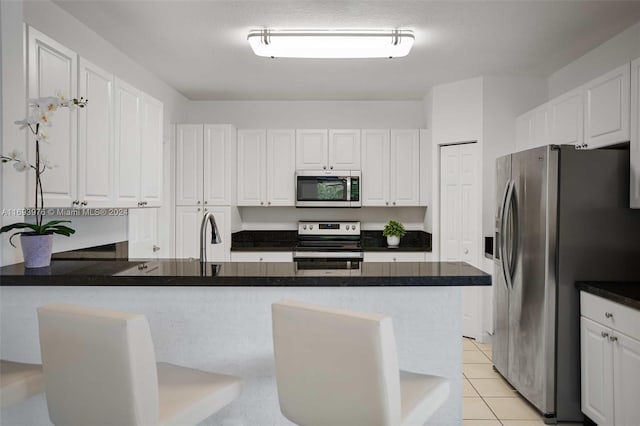 kitchen with appliances with stainless steel finishes and white cabinetry