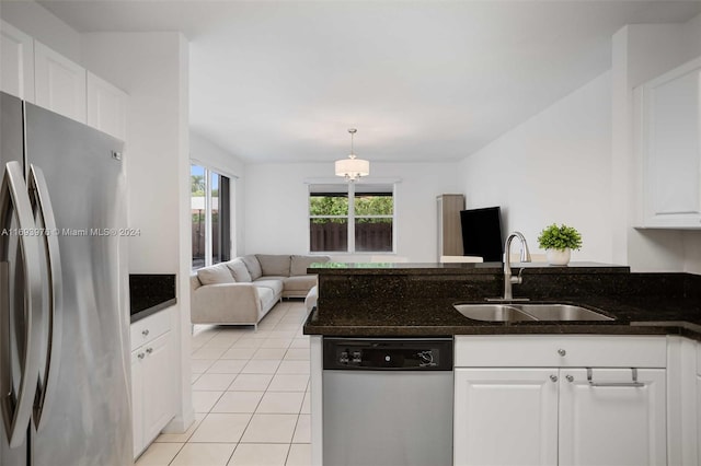 kitchen with sink, white cabinets, decorative light fixtures, and appliances with stainless steel finishes