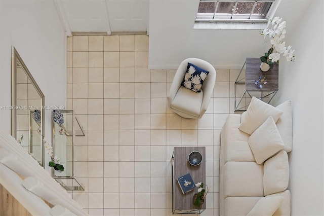 bathroom featuring ornamental molding, tile walls, and tasteful backsplash