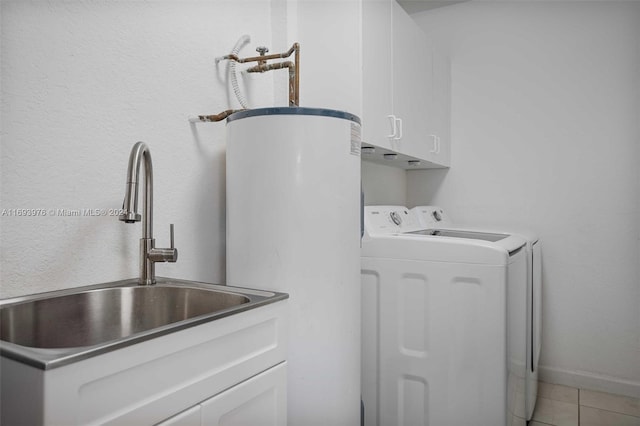 washroom featuring cabinets, tile patterned floors, sink, water heater, and washing machine and clothes dryer