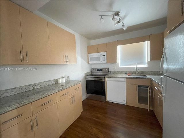 kitchen with white appliances, sink, dark hardwood / wood-style floors, light brown cabinetry, and light stone counters