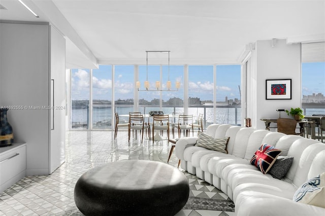 living room featuring expansive windows, plenty of natural light, and a water view