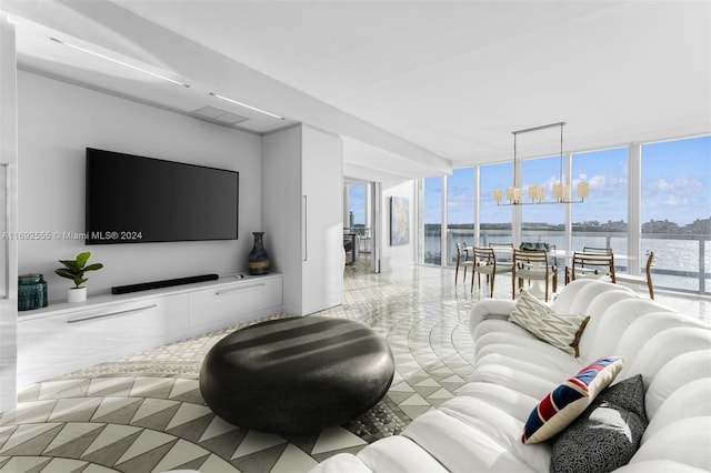 living room with a wall of windows, plenty of natural light, a water view, and a notable chandelier