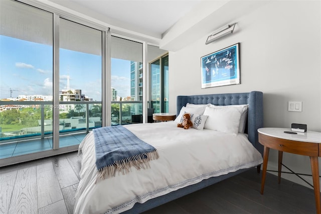 bedroom featuring access to outside and hardwood / wood-style flooring