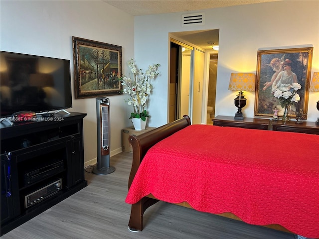 bedroom with wood-type flooring