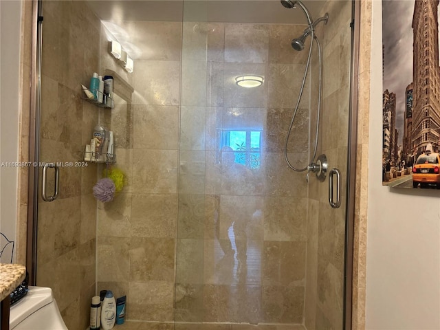 bathroom with an enclosed shower and toilet