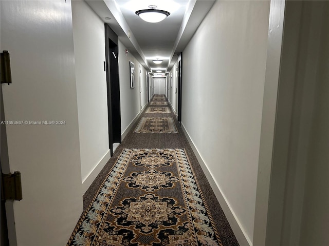 hallway with dark carpet