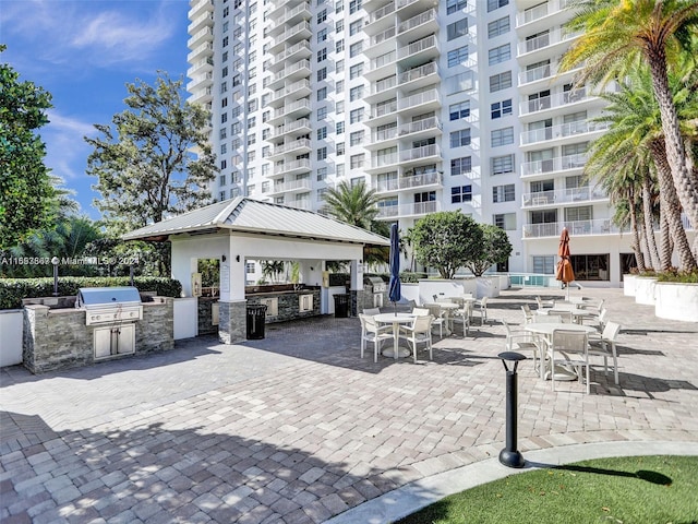 view of home's community with a gazebo, a patio, and exterior kitchen