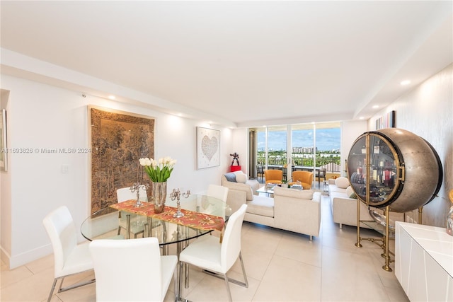 dining space with floor to ceiling windows and light tile patterned flooring