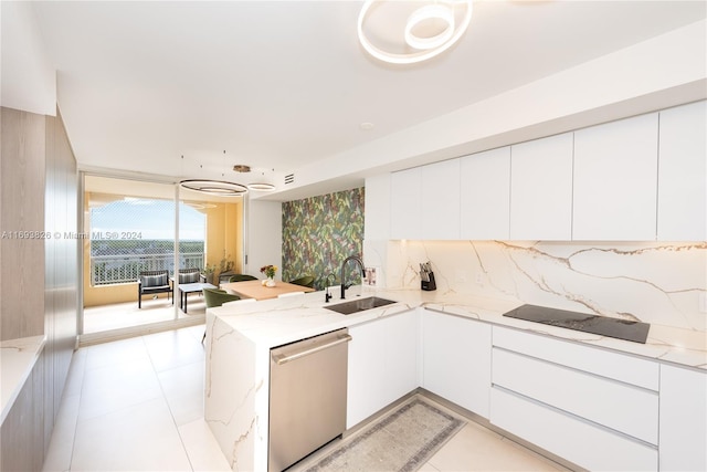 kitchen with dishwasher, white cabinetry, and sink