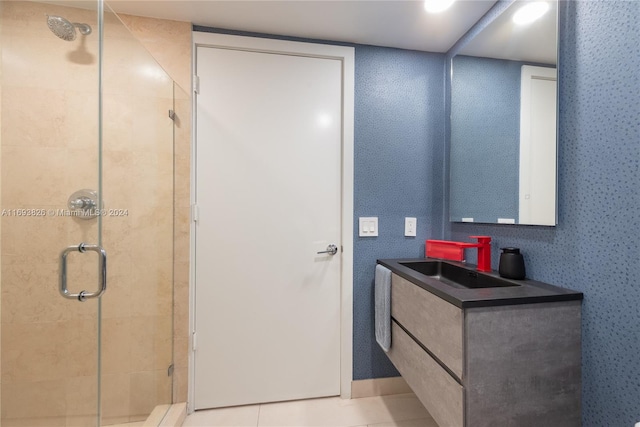 bathroom with tile patterned flooring, vanity, and a shower with door