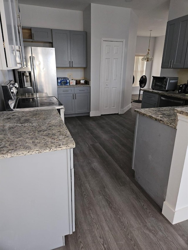 kitchen featuring range with electric stovetop, gray cabinets, pendant lighting, and light stone counters