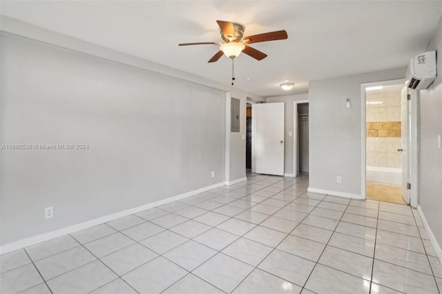 empty room with a wall mounted AC, ceiling fan, electric panel, and light tile patterned flooring