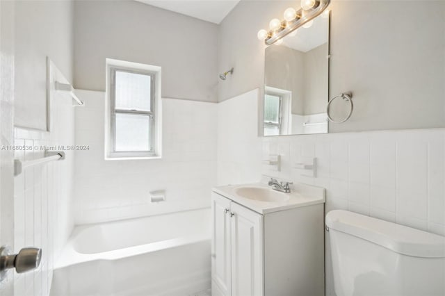 full bathroom featuring shower / bathing tub combination, vanity, toilet, and tile walls