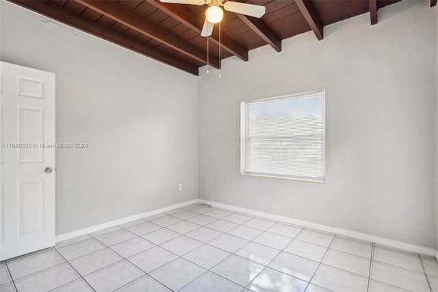 tiled empty room with lofted ceiling with beams, ceiling fan, and wood ceiling