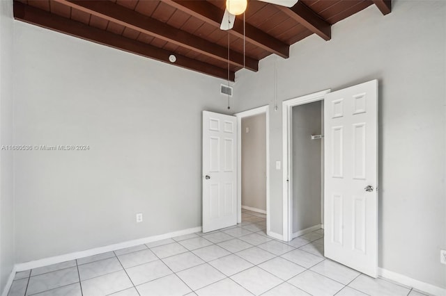 unfurnished bedroom featuring beamed ceiling, ceiling fan, wooden ceiling, and light tile patterned floors