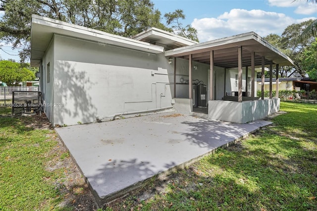 rear view of property with a yard and a patio