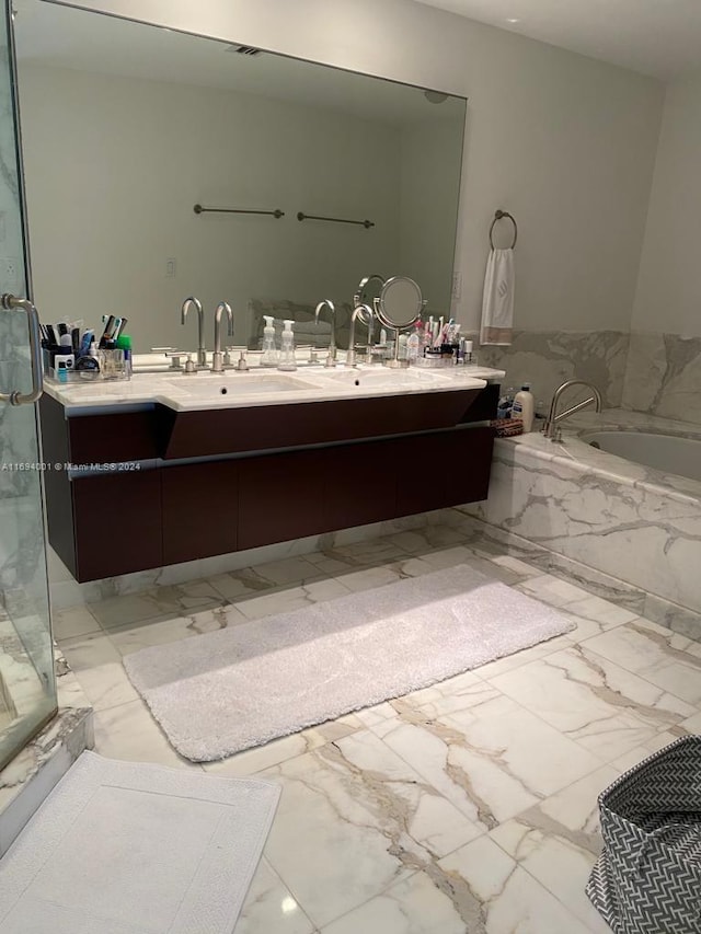 bathroom featuring vanity and a relaxing tiled tub