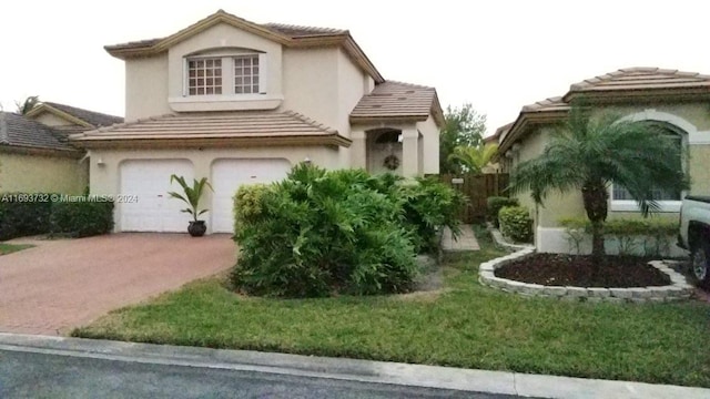 view of front of home with a front lawn and a garage