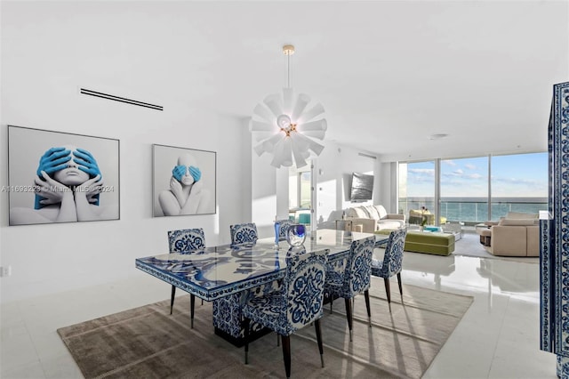 dining room with a wall of windows and an inviting chandelier